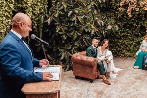 Professional wedding officiant leading a symbolic ceremony in Spain